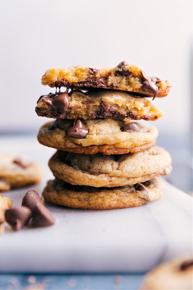 Chocolate Chip Pudding Cookies Are Simple And Delicous Stack of Chocolate Chip Pudding Cookies with one broken in half to reveal the soft, gooey center.