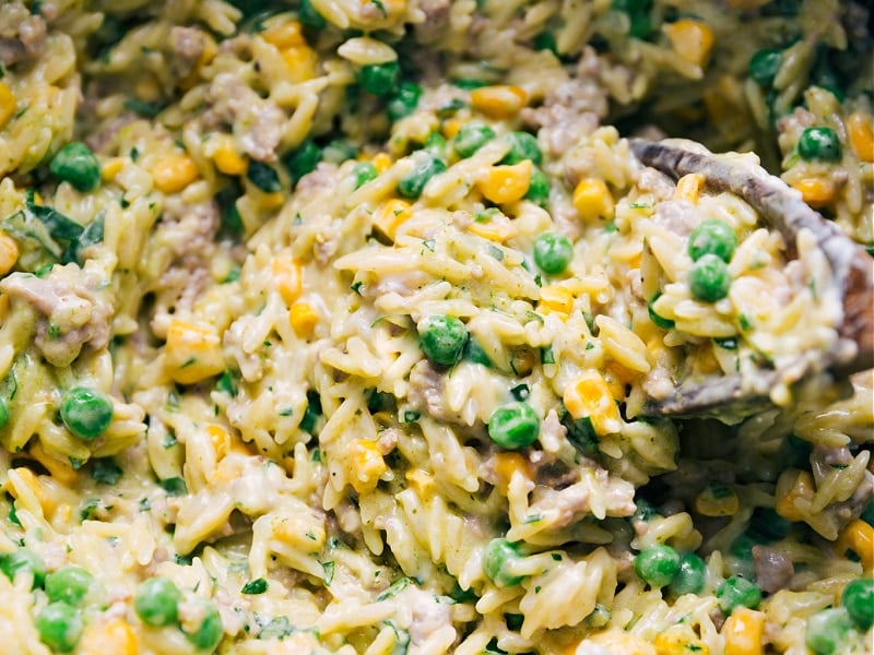 The best ever 30-minute Creamy Pesto Orzo! Recipe via ChelseasMessyApron #dinner #quick #easy #simple #best #peas #corn #comfortfood #kidfriendly #creamy #pesto #orzo Close-up view of Creamy Pesto Orzo