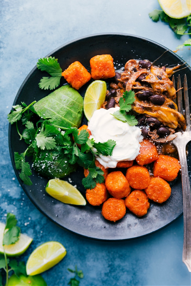 This meal is made on one sheet pan with less than 10 ingredients! Recipe via ChelseasMessyApron #dinner #quick #easy #simple #best #30mins #avocado #cheese #tatertots #sweetpotato #deconstructed #beef #totchos Process shots-- Deconstructed Beef Totchos