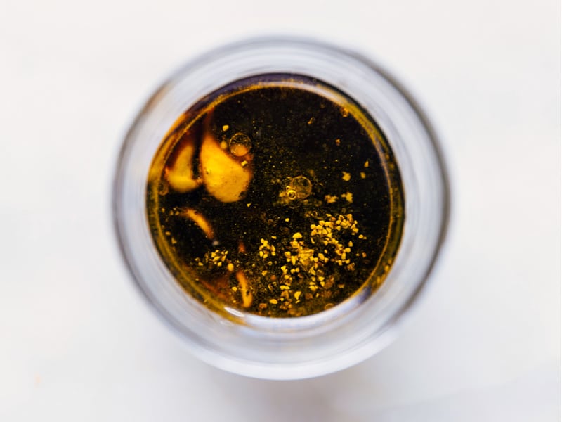 This simple Balsamic Vinaigrette takes mere minutes to whip together and no special kitchen appliances needed! Recipe via ChelseasMessyApron #salad #saladdressing #clean #healthy #sidesalad #balsamic #vinaigrette Overhead image of the dressing with all the ingredients added