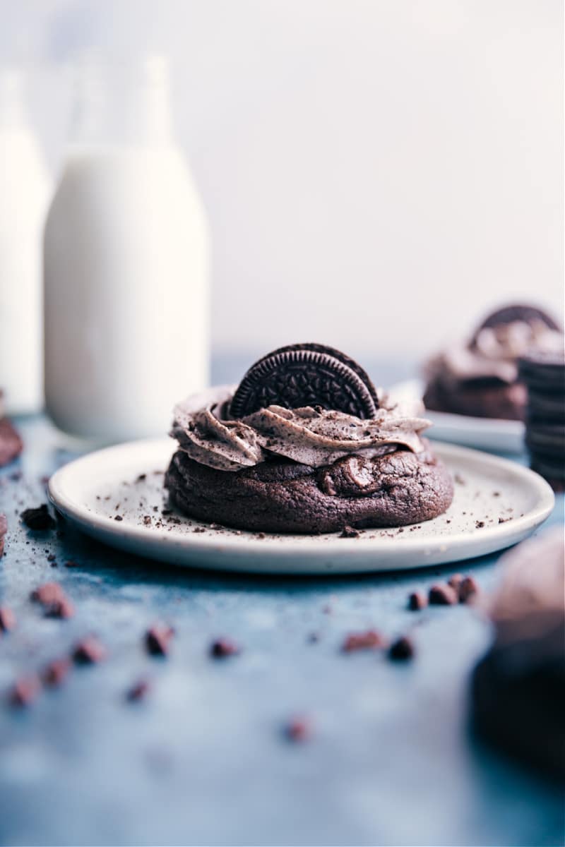 These Chocolate Oreo Cookies start with thick and gooey, chocolate-studded, and Oreo-loaded chocolate cookies that get piled high with the best cookies and cream frosting. Recipe via ChelseasMessyApron.com #cookies #chocolate #oreo #bakerystyle #decadent #cookiesandcream Image of the Chocolate Oreo Cookies on a plate