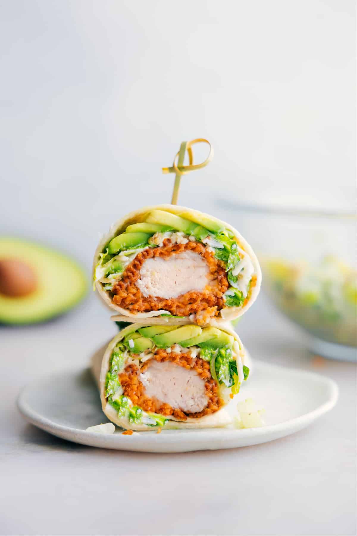 Chicken Caesar Wrap Recipe Chicken Caesar Wrap cut in half showing the insides of one of the wraps.