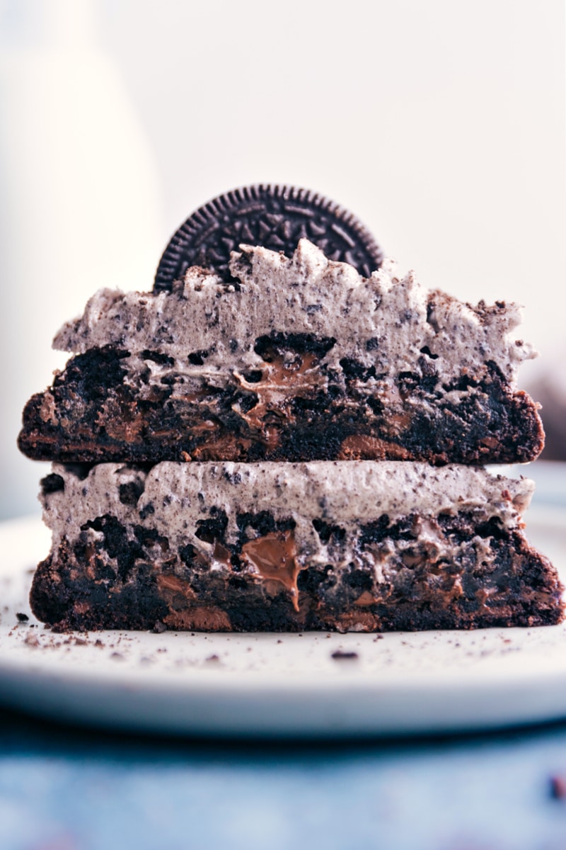 These Chocolate Oreo Cookies start with thick and gooey, chocolate-studded, and Oreo-loaded chocolate cookies that get piled high with the best cookies and cream frosting. Recipe via ChelseasMessyApron.com #cookies #chocolate #oreo #bakerystyle #decadent #cookiesandcream Chocolate Oreo Cookies stacked on top of each other