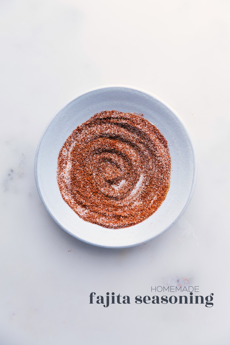 Our favorite Fajita Seasoning blend is so simple to make and uses spices you probably already have in your cabinet! Skip the store-bought packets; you'll never want to use them again after seeing how easy and delicious making your own seasoning blends is. Recipe via ChelseasMessyApron #homemade #mexican #fajita #seasoning #mix Overhead image of Fajita Seasoning mix