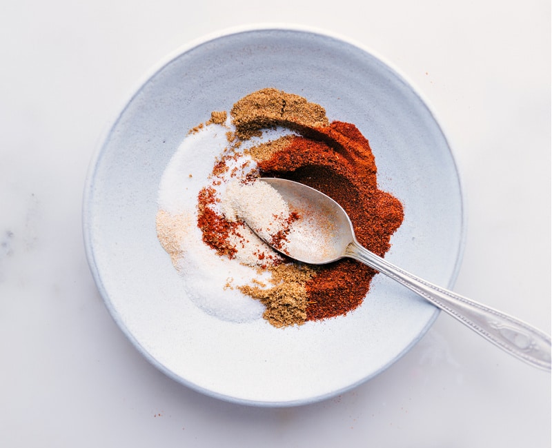 Our favorite Fajita Seasoning blend is so simple to make and uses spices you probably already have in your cabinet! Skip the store-bought packets; you'll never want to use them again after seeing how easy and delicious making your own seasoning blends is. Recipe via ChelseasMessyApron #homemade #mexican #fajita #seasoning #mix Process shot of the Fajita Seasoning blend-- image of the seasonings being mixed together