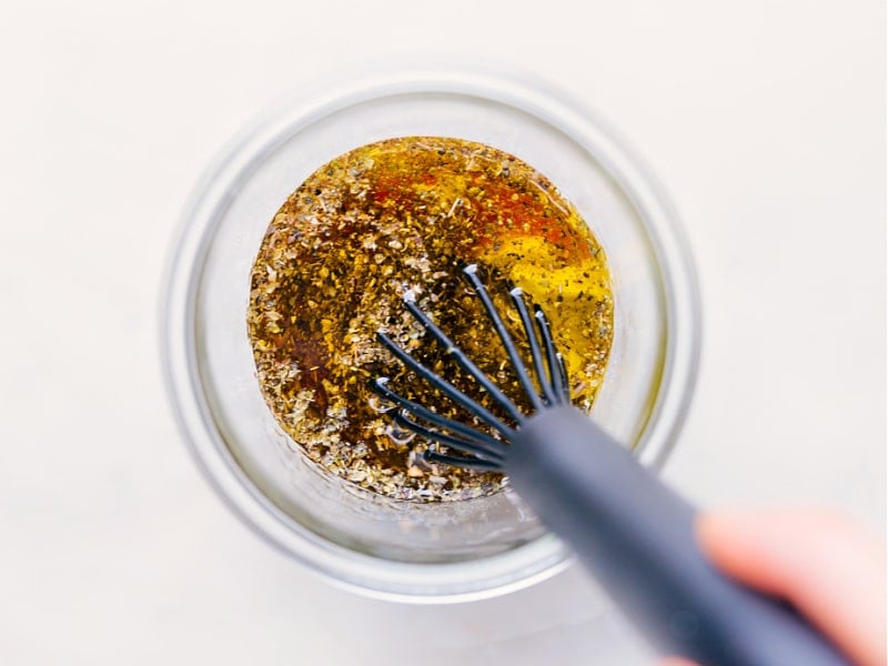 The best ever Italian Dressing made from scratch is a complete game changer -- it's so much better than store-bought! This dressing combines good olive oil with dried herbs, Dijon mustard, and red wine vinegar for a bright and tangy dressing sure to please a crowd! Recipe via ChelseasMessyApron #quick #easy #simple #healthy #best #vinagrette #italian #dressing Process shots-- images of the dressing being whisked together