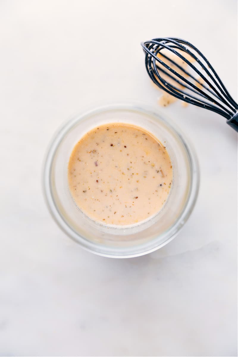Italian Dressing made from scratch is a complete game changer -- it's so much better than store-bought! Recipe via ChelseasMessyApron #quick #easy #simple #healthy #best #vinagrette #italian #dressing Italian Dressing recipe ready to be served on a salad.