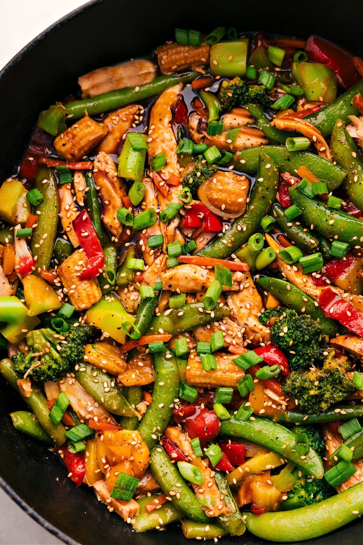 30-Minute One Skillet Rotisserie Chicken Stir Fry The rotisserie chicken stir fry with its delicious sauce sits in the skillet, ready to serve and enjoy.