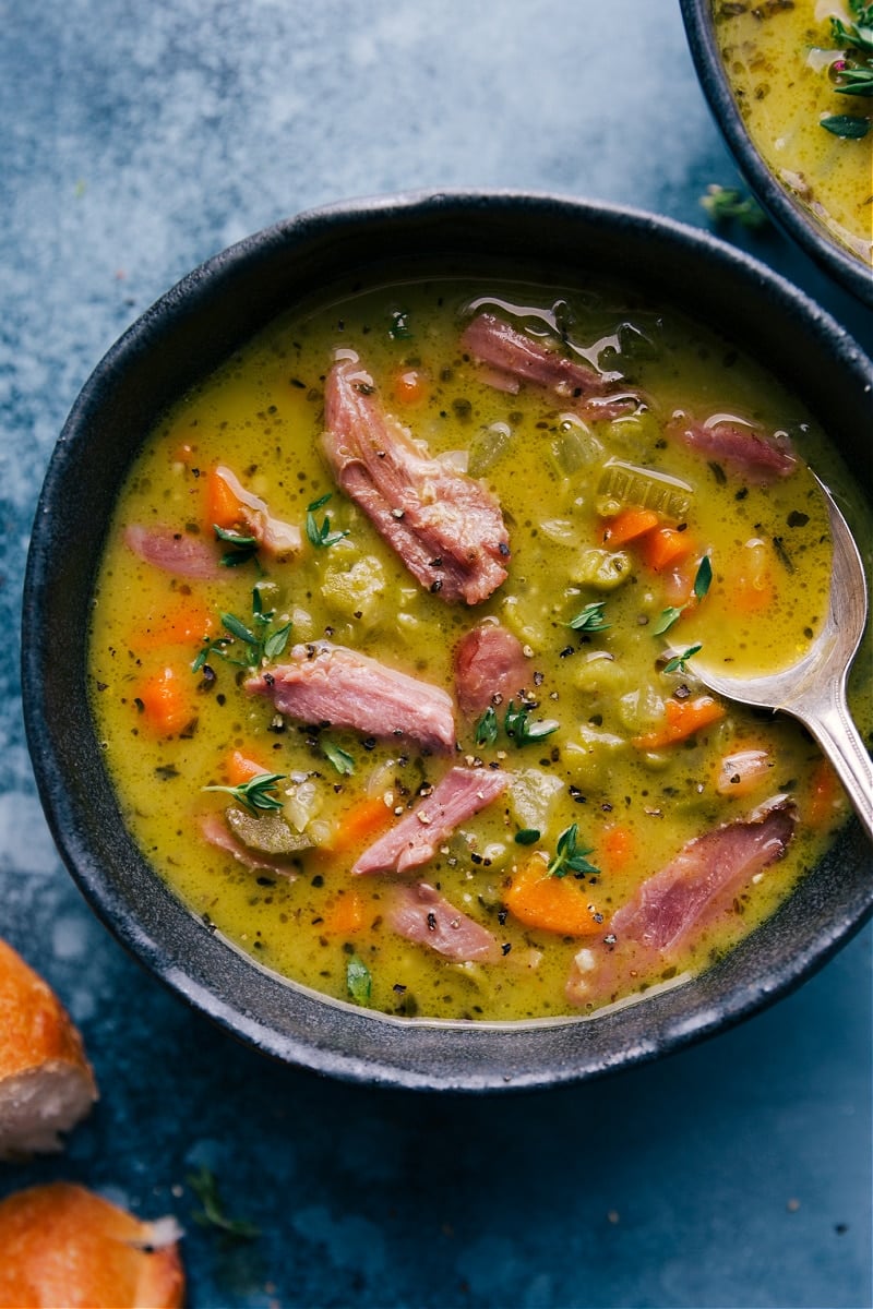 Split Pea Soup is richly flavored, thick, and creamy-- and loaded with veggies, split peas, and tender shredded ham. This humble-looking soup is anything but humble tasting! Recipe via ChelseasMessyApron #dinner #quick #easy #simple #best #comfortfood #familyfriendly #splitpea #soup Overhead image of Split Pea Soup in a bowl
