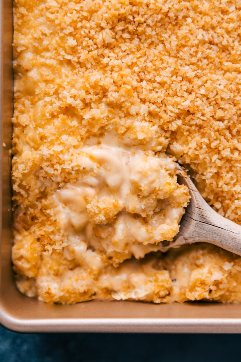 The is the best Baked Mac and Cheese we've ever tasted! It's ridiculously creamy, cheesy, and rich with the perfect blend of cheeses and the ultimate crispy topping! Plus, it's not a recipe you need to slave over all day -- we've made it as simple as possible! Recipe via ChelseasMessyApron #dinner #quick #easy #simple #comfortfood #familyfriendly #creamy #kidfriendly #baked #macandcheese Overhead image of Baked Mac and Cheese