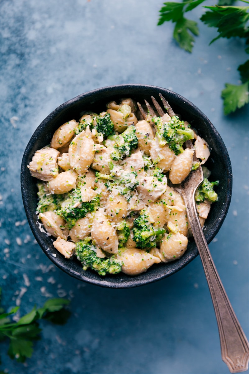 Chicken And Broccoli Pasta combines saucy pasta shells with tender broccoli and seasoned chicken in the quickest garlic-butter Alfredo sauce. Sprinkle on some Parmesan and be prepared to have a new pasta addiction! Recipe via ChelseasMessyApron #dinner #quick #easy #simple #best #chicken #broccoli #pasta Overhead image of the Chicken and Broccoli Pasta in a bowl