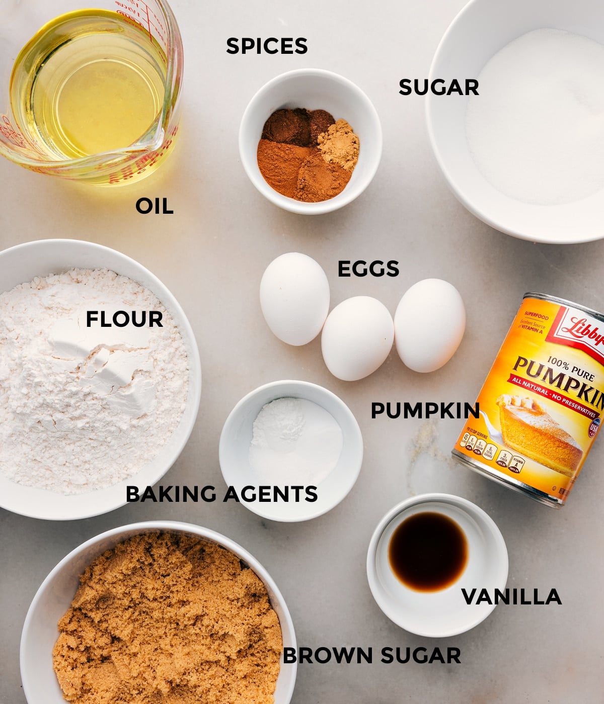 Ingredients In The Best Pumpkin Bars Recipe All the ingredients in this recipe including oil, sugar, spices, eggs, flour, baking agents, and pumpkin prepped out for easy assembly.