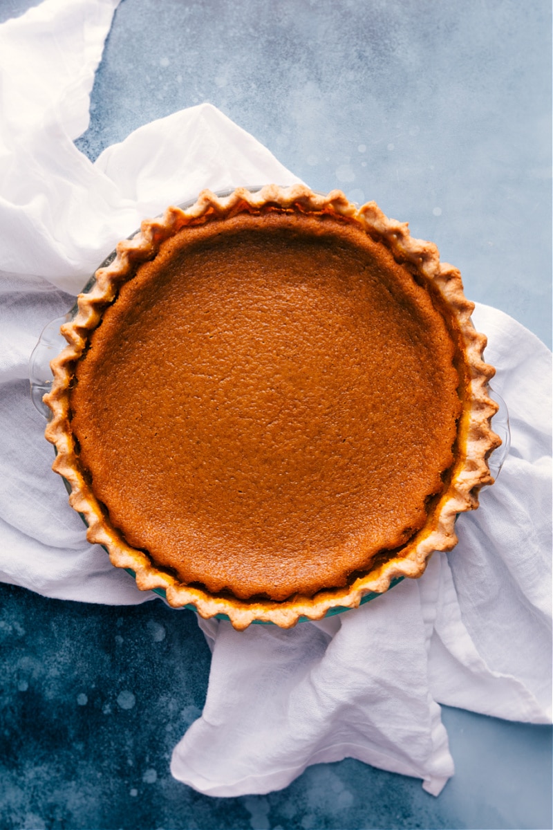 The Best Pumpkin Pie Recipe Freshly baked Pumpkin Pie recipe in a pan, golden and set just out of the oven.