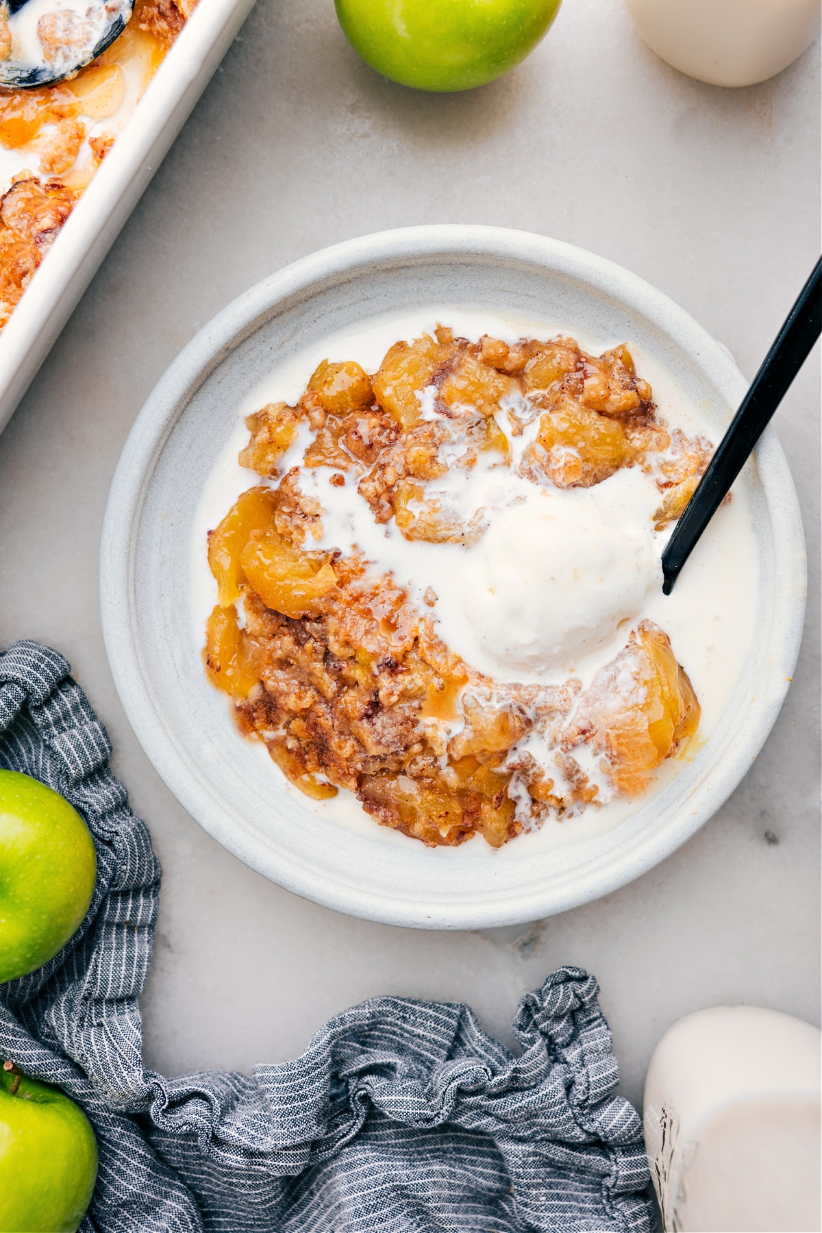 The Best Apple Dump Cake With Ice Cream Apple Dump Cake on a plate with ice cream.