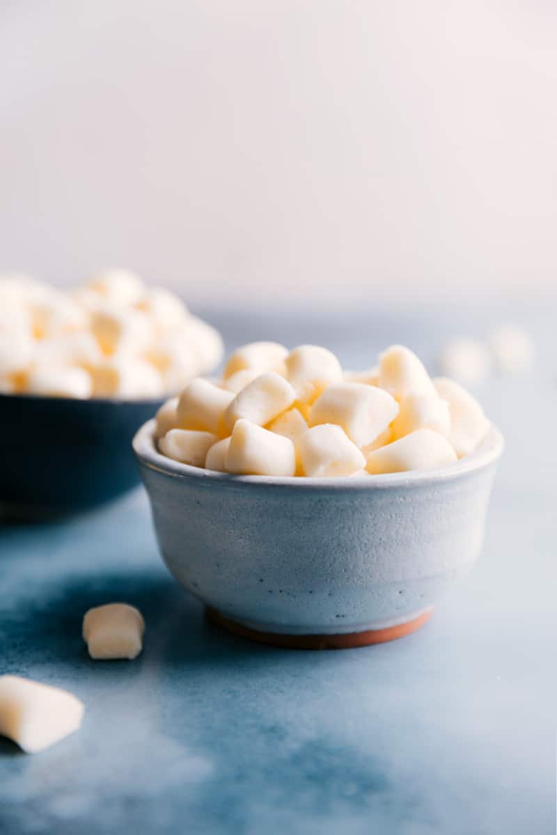 This Butter Mints recipe delivers sweet and pepperminty confections with a soft and creamy, melt-in-your-mouth interior. No candy thermometer needed. Instead of looking where to buy butter mints, give this homemade version a try! Recipe via ChelseasMessyApron.com #buttermints #candy #homemade #easy #mints #treat #party #special A bowl of Butter Mints