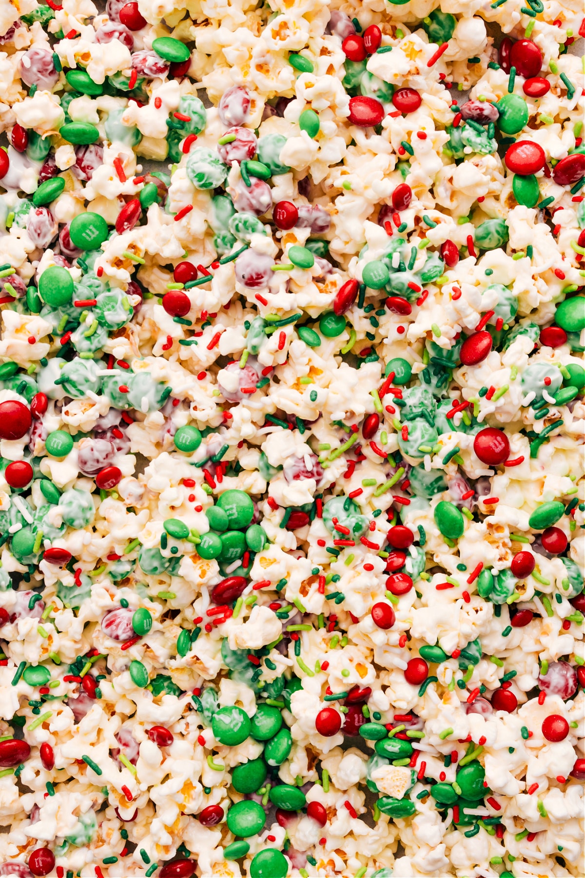 Three-Ingredient Christmas Popcorn Spread Christmas Popcorn on a sheet pan and add toppings.