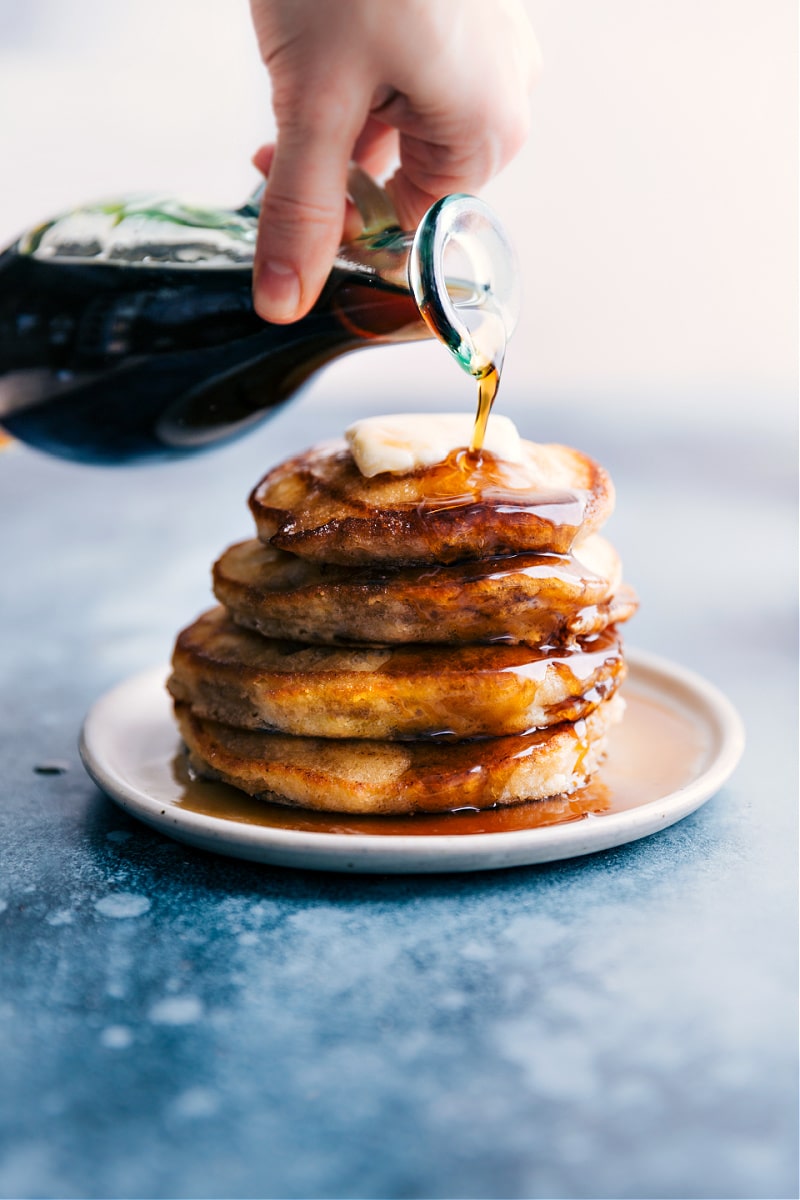 Pancake Syrup -- you'll be amazed how quick and easy it is! Plus, when you make it yourself, you don't have to worry about any artificial ingredients or corn syrup. Recipe via ChelseasMessyApron #dessert #best #quick #easy #simple #breakfast #sauce #brunch #pancake #syrup Overhead image of Pancake Syrup being poured over the pancakes