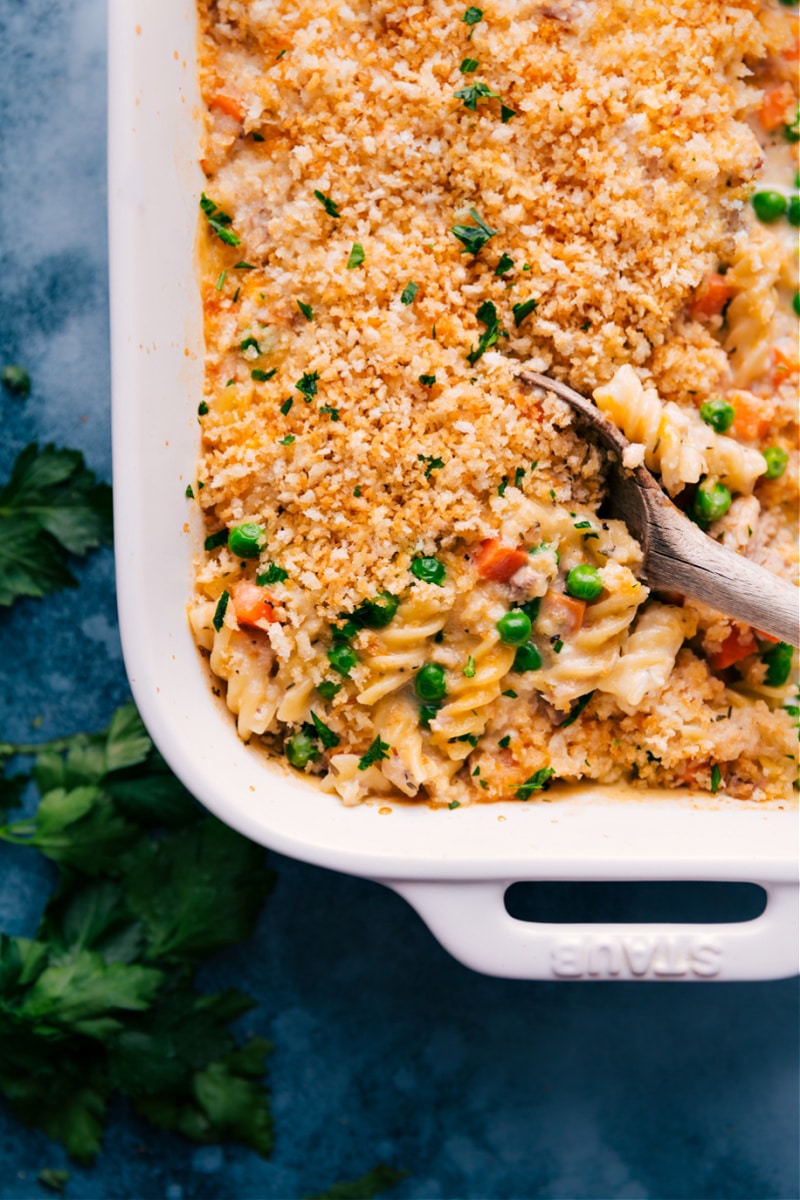 This easy Tuna Casserole is completely assembled and prepared in one pan -- throw uncooked pasta, tuna, and veggies into a baking dish with a handful of other ingredients and watch in amazement as it bakes to creamy perfection! Recipe via ChelseasMessyApron #dinner #quick #easy #simple #best #onepan #tuna #casserole Overhead image of Tuna Casserole