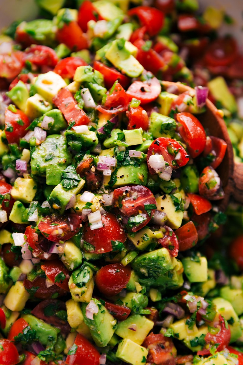This Avocado Salsa is our favorite! It's got a wonderful, fresh, and vibrant flavor with the best juxtaposition of textures -- crisp garden veggies with a delightful creaminess from the avocado. Recipe via ChelseasMessyApron #sidedish #dip #best #quick #easy #simple #snack #gameday #chips #avocado #salsa Overhead image of Avocado Salsa