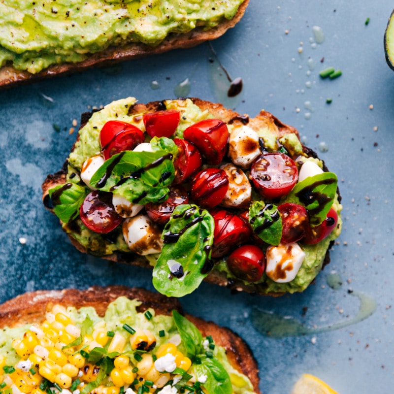 The best Avocado Toast recipes ever -- five different ways to make this nutritious, filling, and tasty breakfast, snack, or lunch. After 5+ years of regularly enjoying Avo Toast, I've narrowed down my family's top favorites and am sharing it all here. Recipe via ChelseasMessyApron #breakfast #quick #easy #simple #healthy #delicious #clean #cleaneating #whole #avocado #toast Overhead image of the Caprese Salad version of Avocado Toast