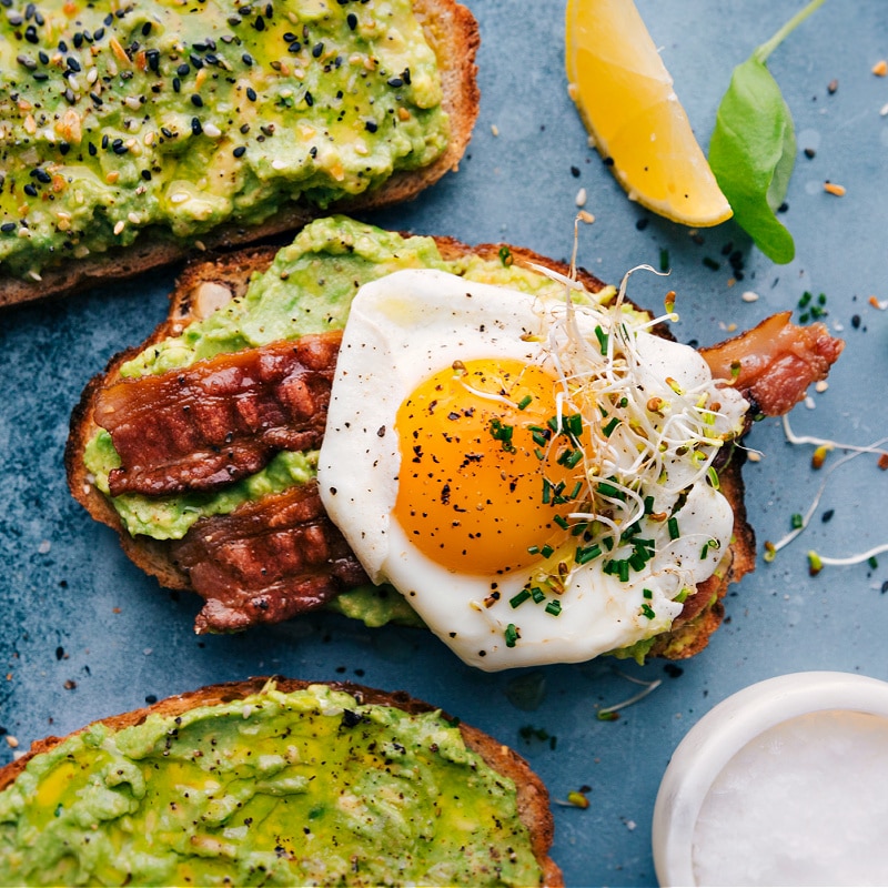 Five different ways to make this nutritious, filling, and tasty breakfast, snack, or lunch. After 5+ years of regularly enjoying Avo Toast, I've narrowed down mine and my family's top favorites and am sharing it all here. Recipe via ChelseasMessyApron #breakfast #quick #easy #simple #healthy #delicious #clean #cleaneating #whole #avocado #toast Overhead image of the breakfast version of Avocado Toast.