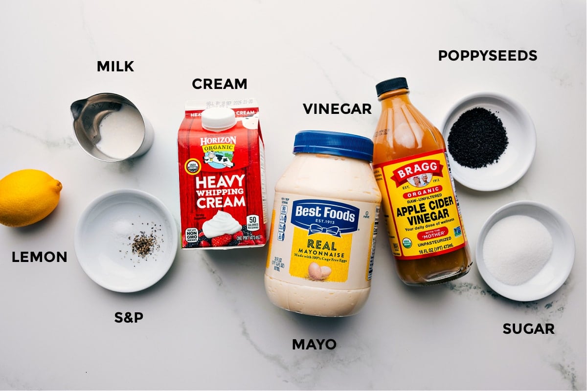 Ingredients In Poppyseed Dressing Recipe All the ingredients in this recipe prepped out for easy assembly including the lemon, milk, cream, seasonings, cream, vinegar, poppyseeds, and sugar.