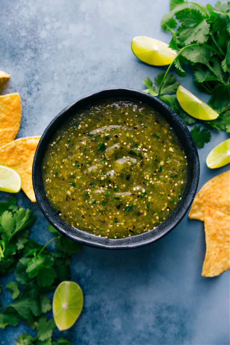 Salsa Verde is our favorite green salsa; instead of tomatoes we use tomatillos which give this sauce it's distinct green color and flavor. This salsa is zesty, tangy, and has a nice underlying smoky flavor from broiling. Grab some chips, you're going to need them! Recipe via ChelseasMessyApron #side #best #quick #easy #simple #mexican #sauce #salsa #verde Overhead image of the Salsa Verde in a bowl