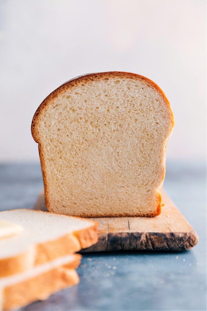 This is our go-to, favorite White Bread recipe made with only six common ingredients. Instead of making a grocery run first, you may already have everything you need! Recipe via ChelseasMessyApron #homemade #best #quick #easy #dough #white #bread a slice of White Bread cut open to show the inside