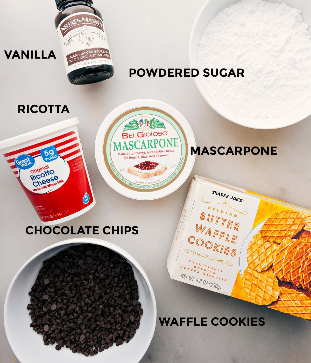 Ingredients In The Best Cannoli Dip Recipe All the ingredients in this recipe including mascarpone, ricotta, powdered sugar, vanilla, and chocolate chips prepped out for easy assembly.