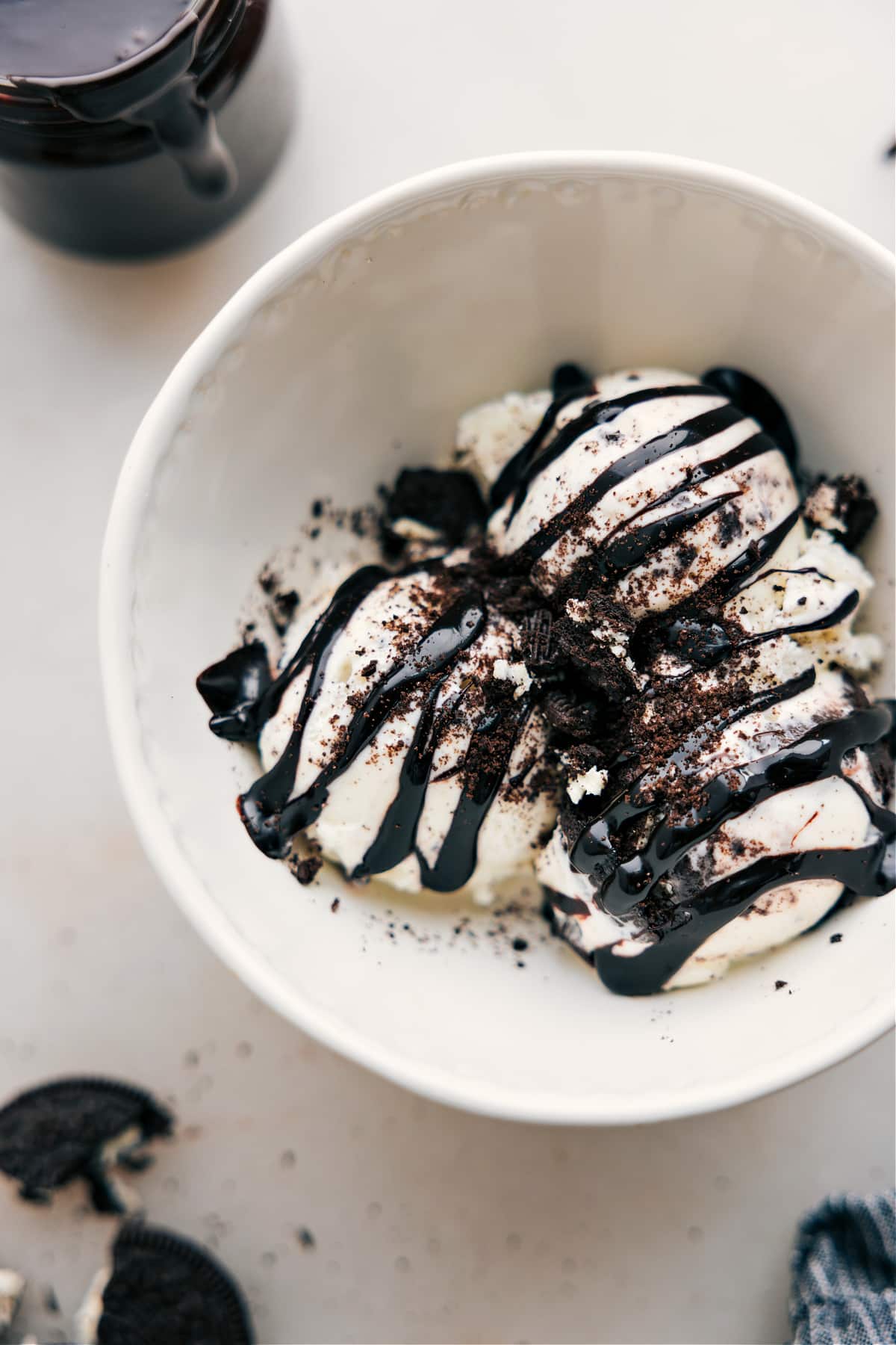 The Best Hot Fudge Recipe Hot Fudge Sauce drizzles over ice cream.