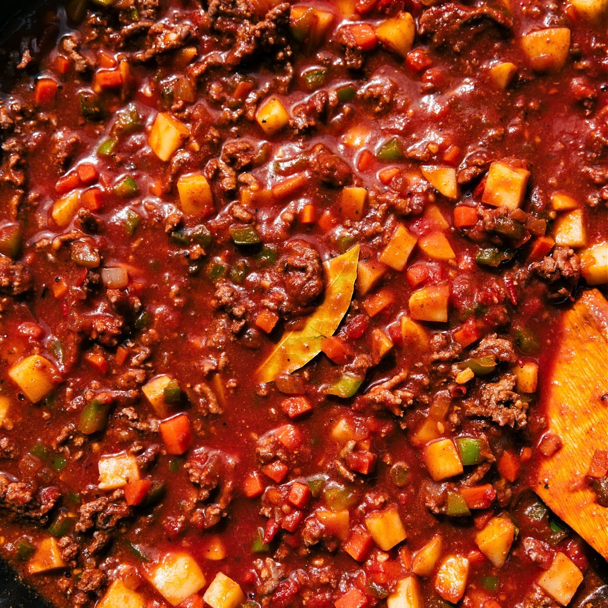 How To Make Mexican Picadillo The dish in a skillet simmering together.