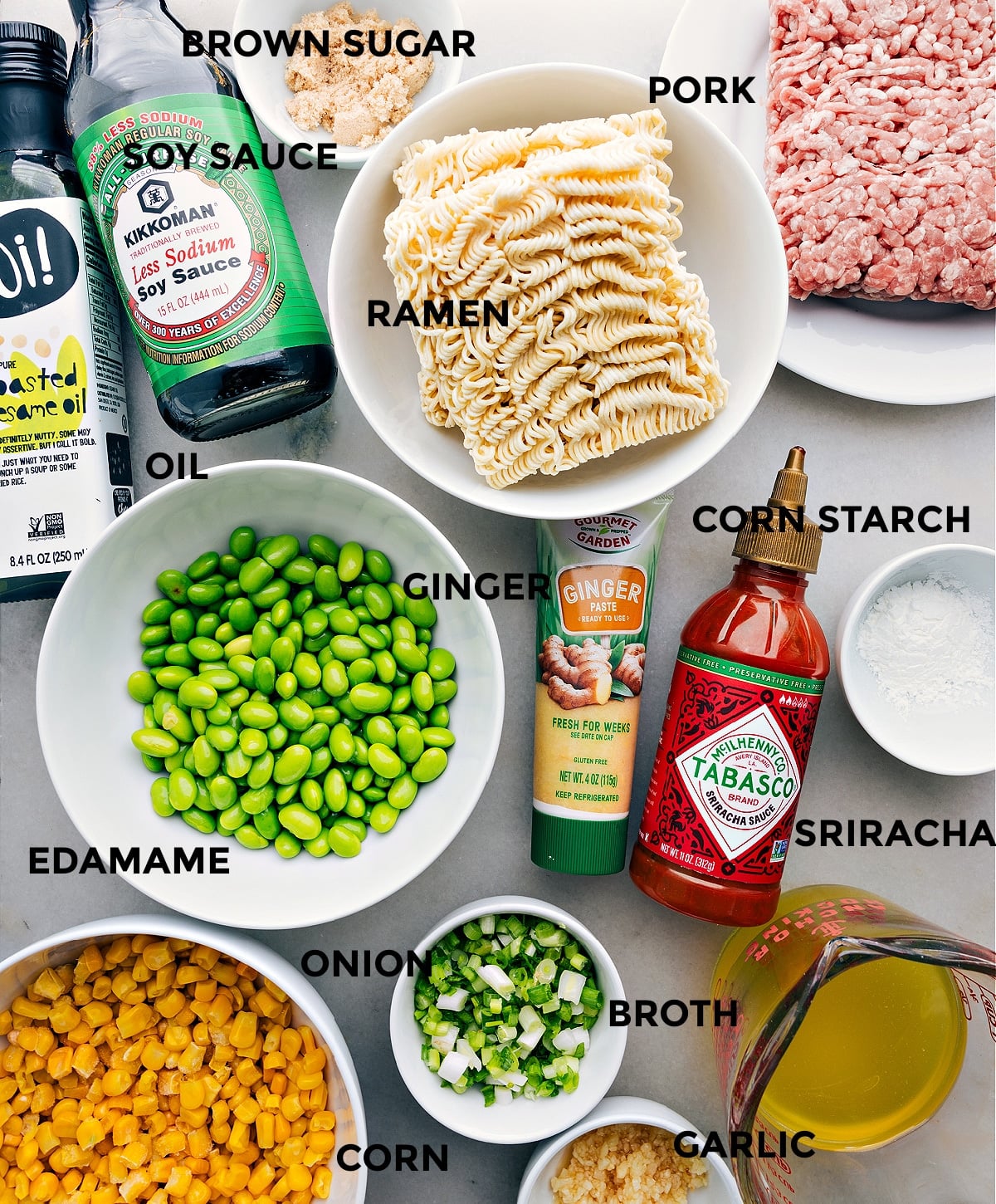 Ingredients In Pork Ramen Stir Fry Recipe All the ingredients including brown sugar, pork, noodles, ginger, cornstarch, edamame, onion, broth, corn, and garlic all prepped out for easy assembly.