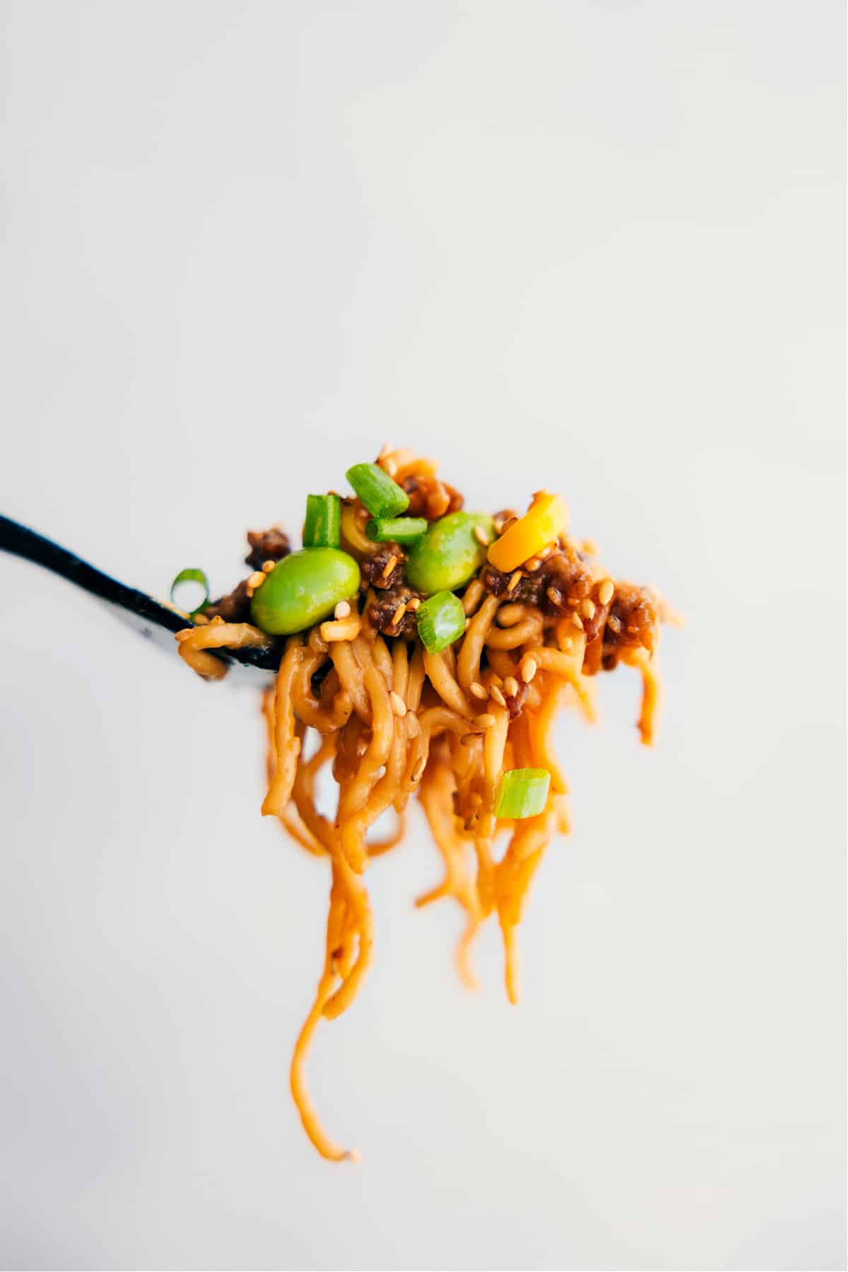 Eating The Best Pork Ramen Stir Fry A big forkful of the Pork Ramen Stir Fry Recipe showing all the yummy ingredients.