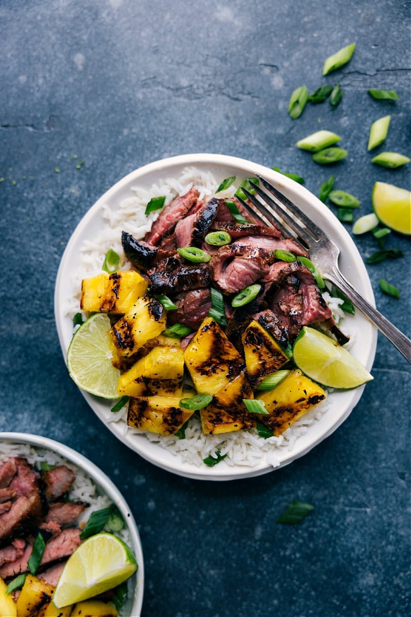 This Pineapple Steak is an explosion of flavor! From the coconut-lime rice to the perfectly seasoned steak to the sweet smoky pineapple topping -- every bite is a treat! Recipe via ChelseasMessyApron #dinner #quick #easy #simple #best #fresh #clean #cleaneating #whole30 #keto #lowcarb #pineapple #chicken Overhead image of the pineapple chicken