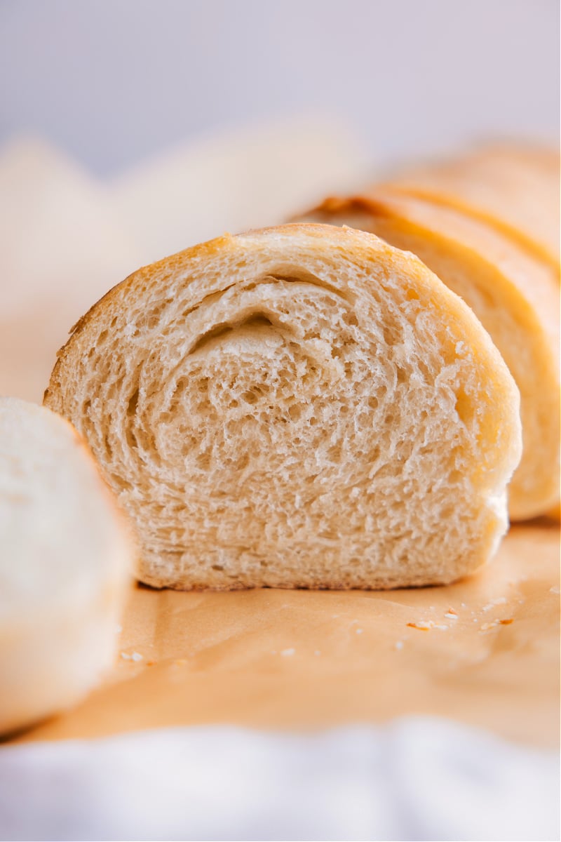 This French Bread is one of our favorite yeasted breads and it's straightforward to prepare-- we've got a video tutorial and step-by-step photos to help you along the process! This bread has a light and soft crumb with a delicious crusty outside. Recipe via ChelseasMessyApron #quick #easy #simple #snack #sandwich #baking #French #bread Image of a slice of the French bread