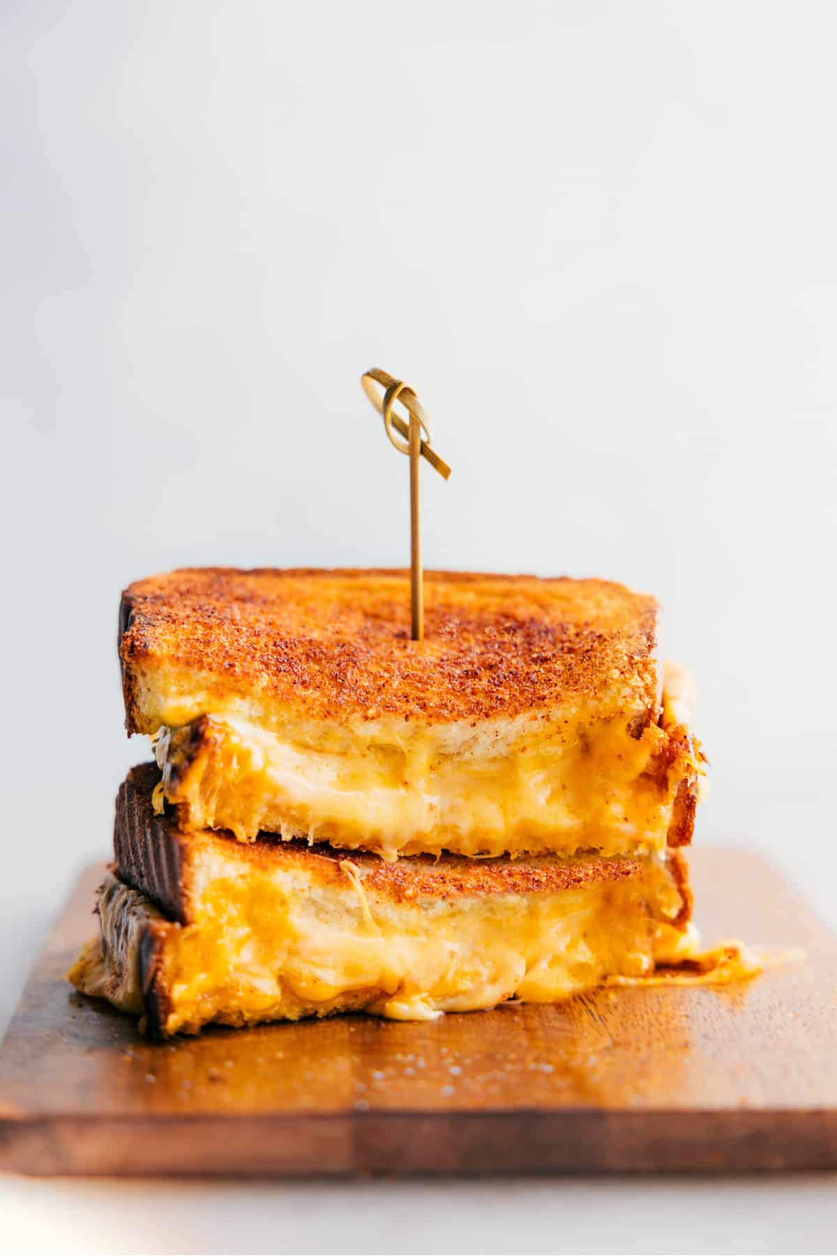 The Best Grilled Cheese Recipe Grilled Cheese stacked on top of each other showing the cheesy center.