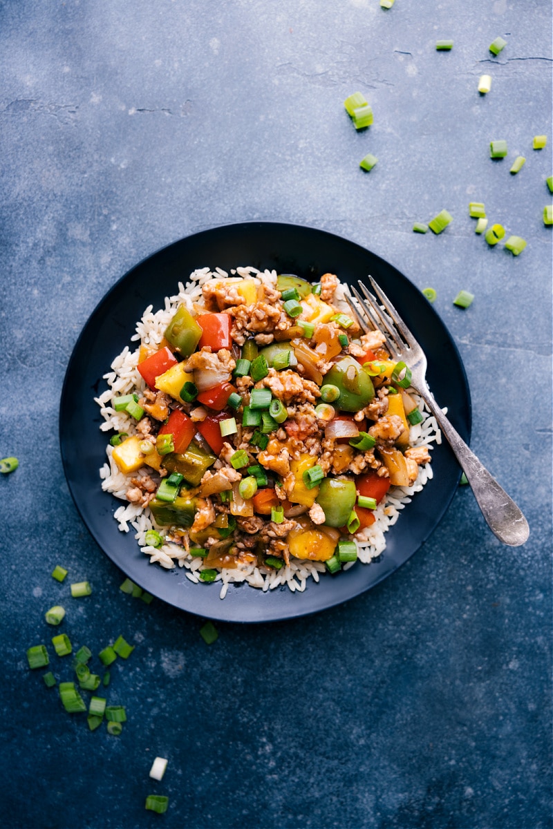 Sweet and Sour Chicken Stir-fry combines veggies, pineapple, ground chicken, and an irresistible stir-fry sauce. This simple-to-make weeknight dinner will be a hit with everyone! Recipe via chelseasmessyapron #dinner #quick #easy #simple #best #familyfriendly #kidfriendly #veggies #sweetandsour #chicken #stirfry Overhead image of the Sweet and Sour Chicken Stir-Fry