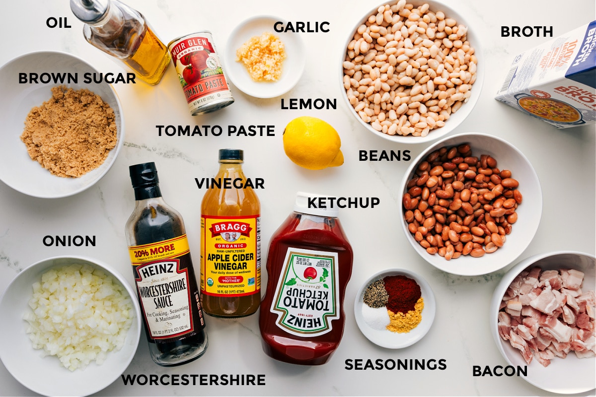 Ingredients In Baked Beans Recipe All the ingredients for baked beans prepped and ready to assemble, including oil, brown sugar, onion, tomato paste, vinegar, Worcestershire, garlic, lemon, ketchup, beans, spices, bacon, and broth.