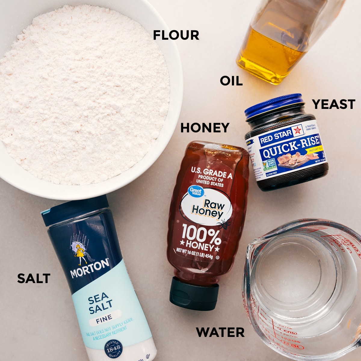 Ingredients In The Best No-Knead Bread Recipe Ingredients for this recipe are prepped for easy assembly: flour, oil, yeast, honey, salt, and water.