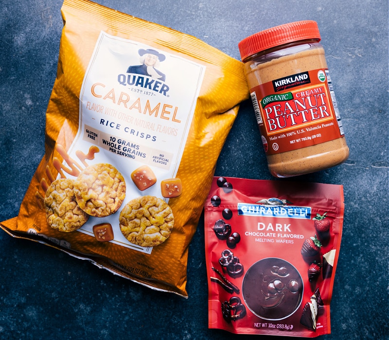 Ingredients In Rice Cake With Peanut Butter Ingredients laid out for easy assembly including the rice cakes, chocolate, and peanut butter.