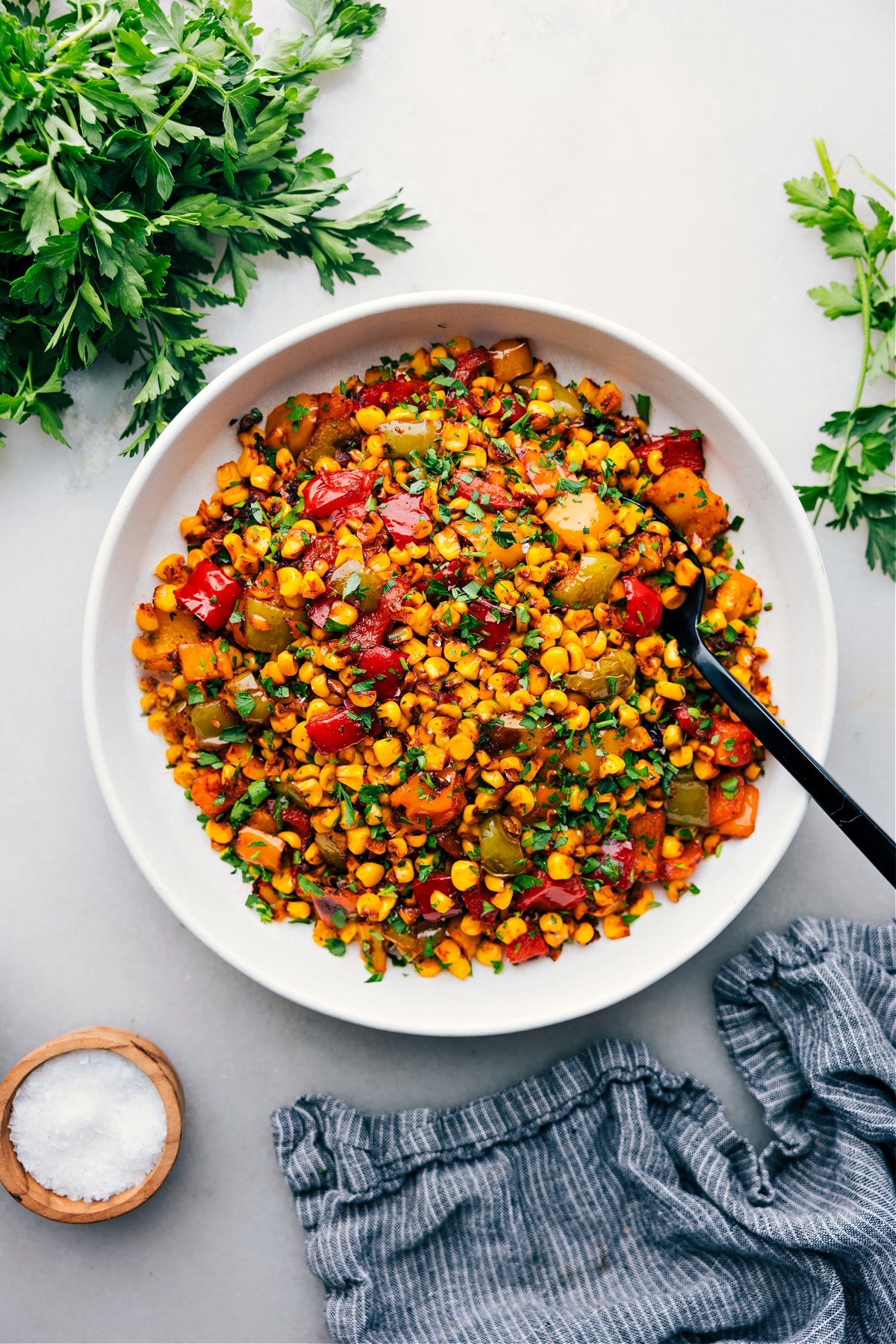 The Best Summer Roasted Corn Recipe Roasted Corn in a bowl ready to be served at your next BBQ or summer event.
