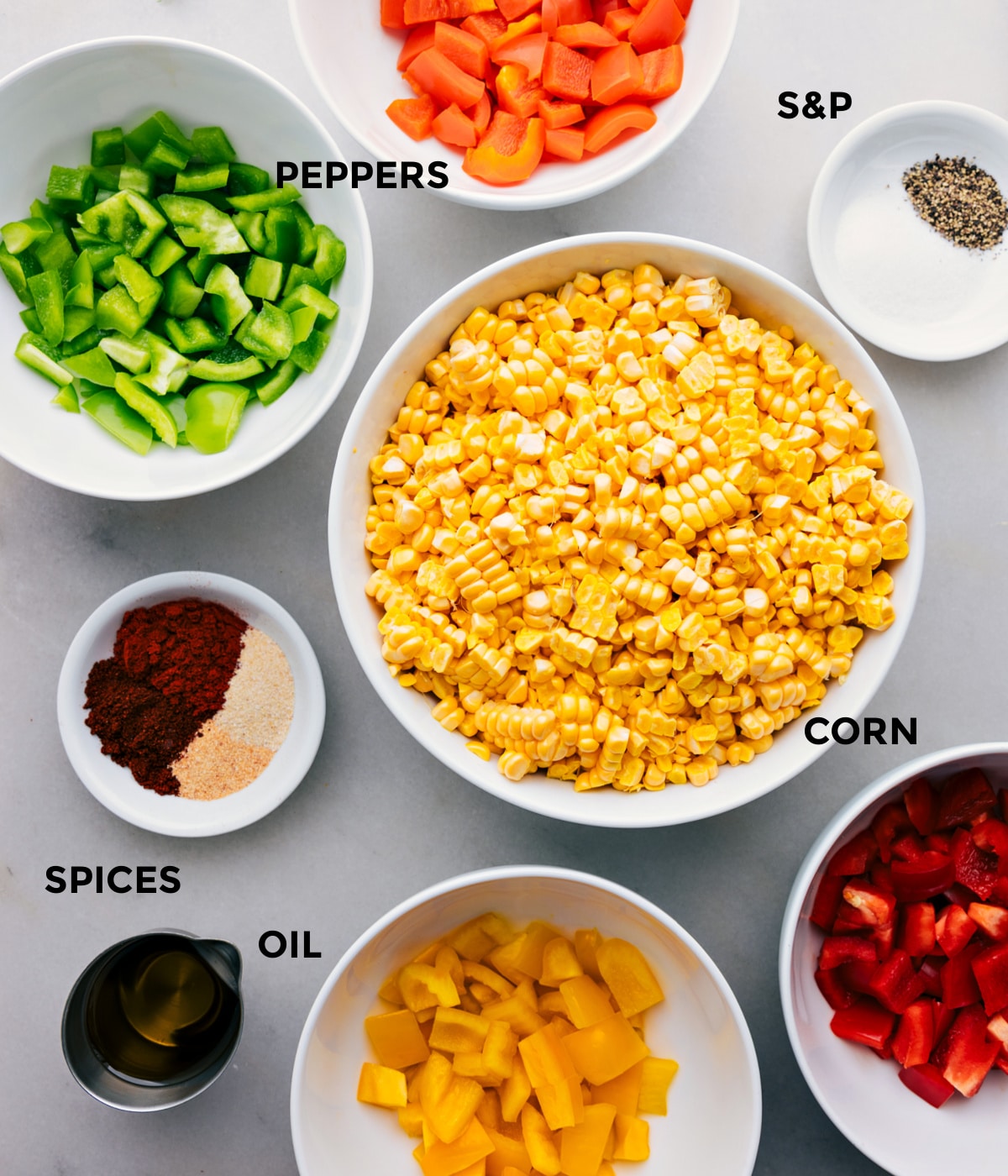 Ingredients In This Roasted Corn Recipe All the ingredients in this recipe including the corn, peppers, oil, spices, and seasonings prepped out for easy assembly.