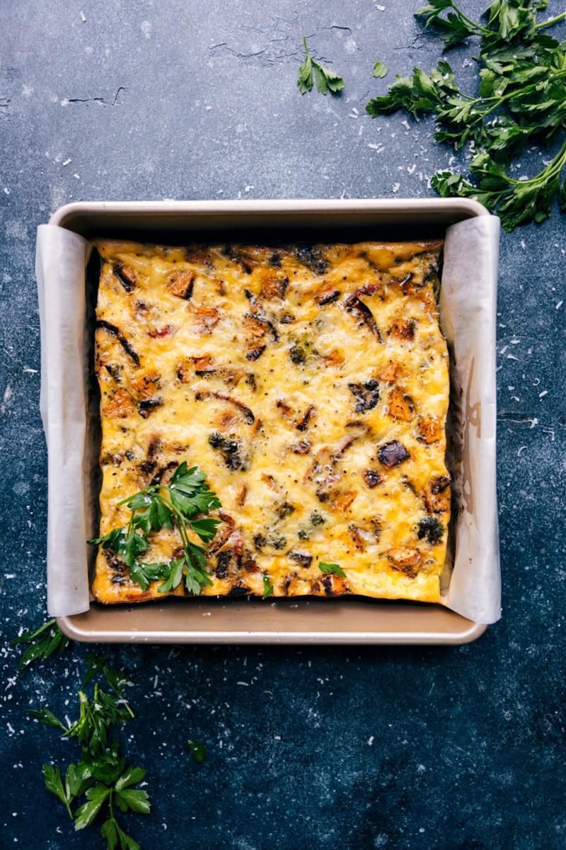 This Vegetable Frittata Recipe is our favorite! Packed with veggies and a creamy seasoned egg mixture, plus some cheese, this dish is sure to be a hit for breakfast, brunch, lunch, or any other time of the day! Recipe via chelseasmessyapron #breakfast #quick #easy #simple #brunch #eggs #frittata Overhead image of the frittata