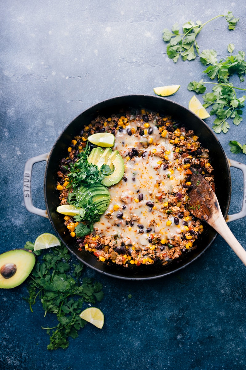 This simple skillet Green Chile Ground Turkey is an explosion of flavor! Well-seasoned ground turkey with savory black beans, crisp corn, and a saucy fire-roasted green chiles base. Easy, 30-minute (or less) weeknight meal! Recipe via ChelseasMessyApron #dinner #quick #easy #simple #best #fresh #healthy #wholefoods #cleaneating #familyfriendly #kidfriendly #greenchile #groundturkey Overhead image of the Green Chile Ground Turkey