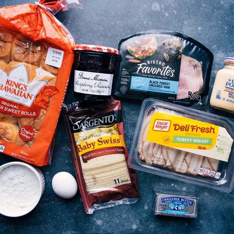 Monte Cristo Sliders are an easier take on the famous Monte Cristo Sandwich! These sliders are baked in an egg custard, topped with powdered sugar, and served with berry jam -- swoon! Recipe via ChelseasMessyApron #dinner #quick #easy #simple #best #fresh #lunch #familyfriendly #kidfriendly #jam #powderedsugar #monte #cristo #montecristo #sliders Ingredient shot-- image of all the ingredients used in Monte Cristo Sliders