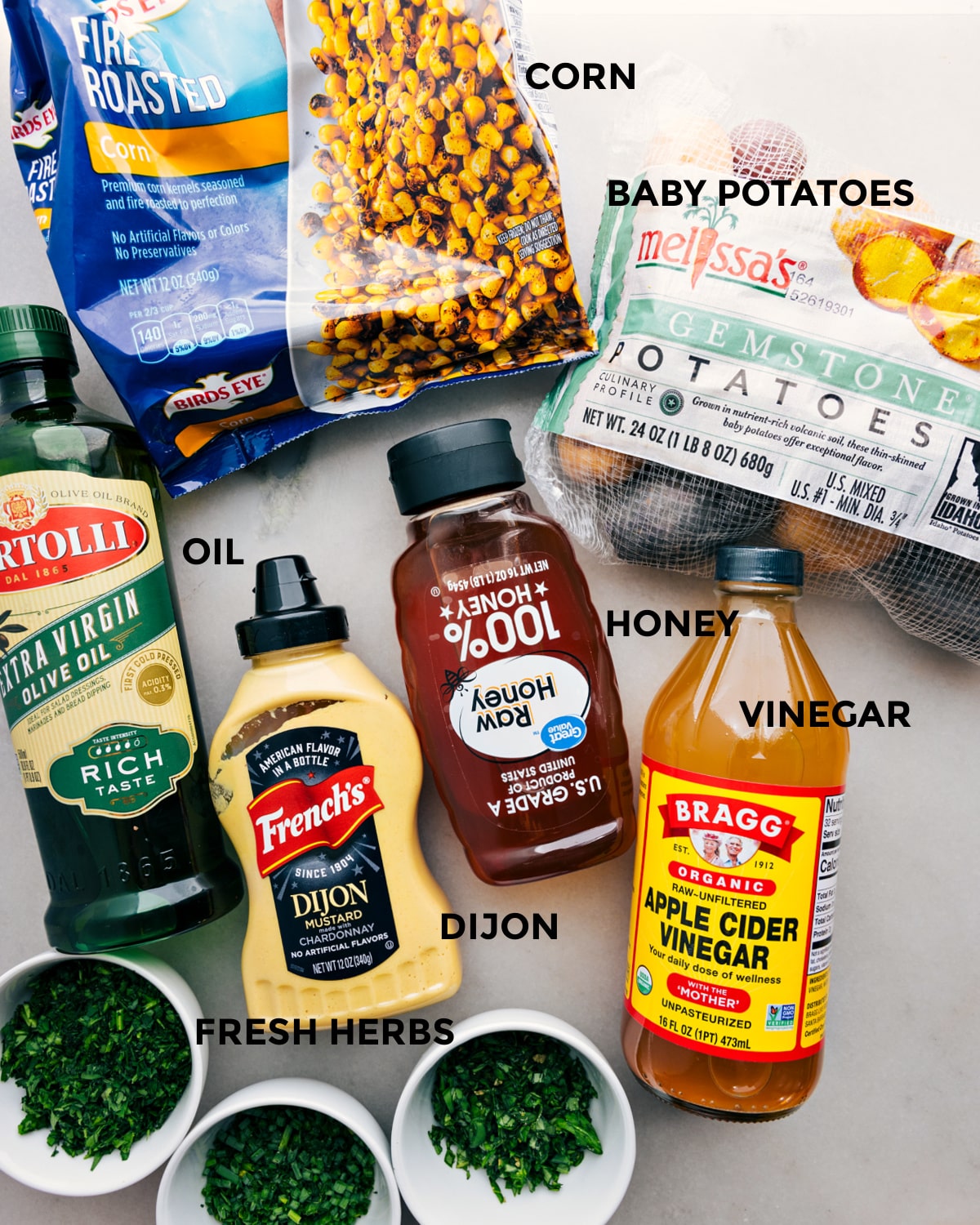 Ingredients In No Mayo Potato Salad Recipe All the ingredients in this recipe including the corn, veggies, oil, dijon, honey, and vinegar prepped out for easy assembly.