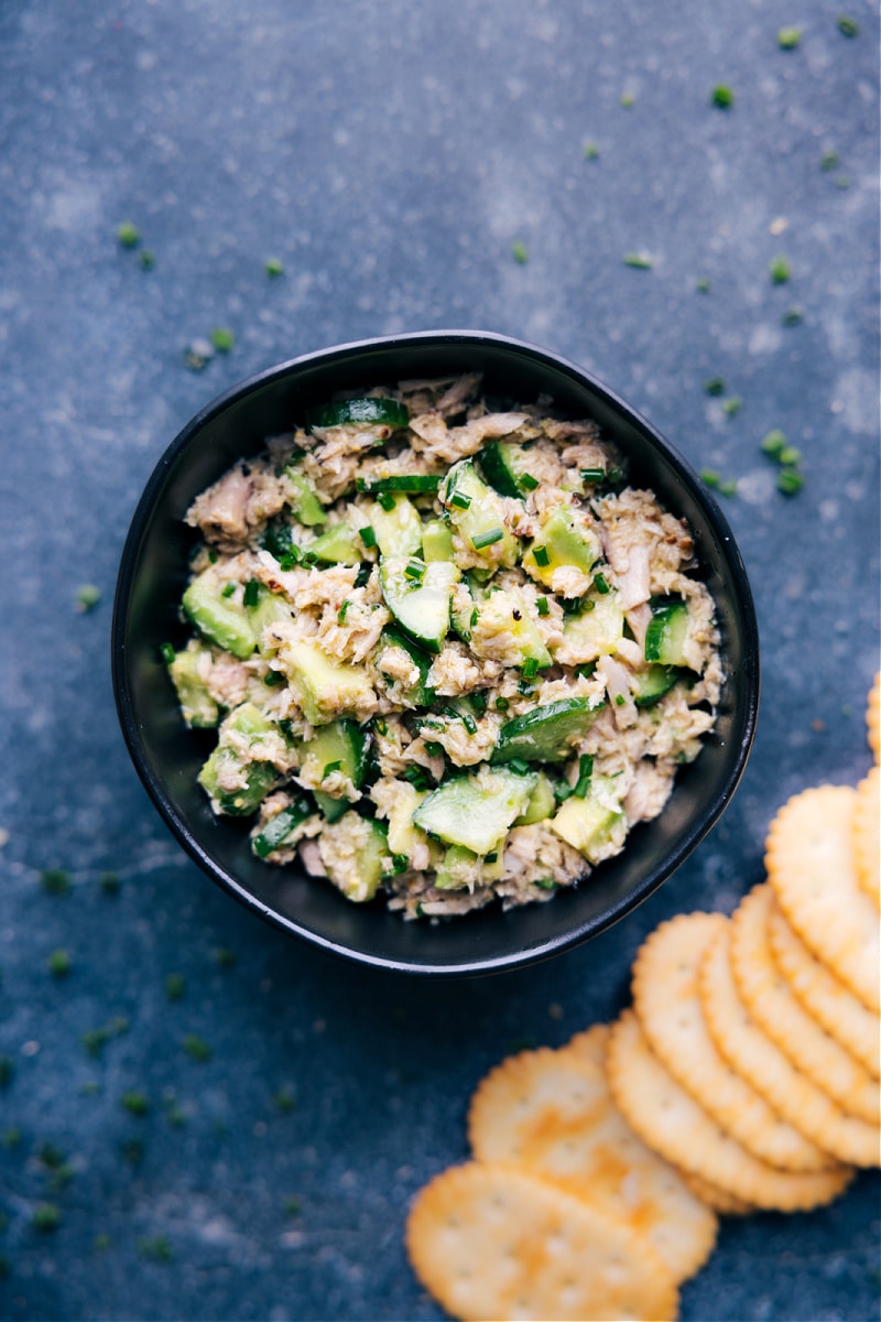 This Tuna Salad NO Mayo dish starts with olive oil-packed tuna, crisp cucumbers, creamy avocado, and garlicky chives dressed in a grainy mustard vinaigrette. Trust me, you won't miss the mayo here! This salad is fresh, vibrant, and nutritious. Recipe via ChelseasMessyApron #dinner #quick #easy #simple #best #fresh #cleaneating #cold #protein #familyfriendly #kidfriendly #tuna #salad #nomayo Overhead image of the tuna salad with no mayo