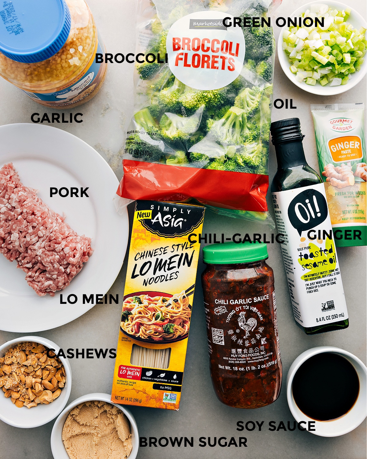 Ingredients In Dragon Noodles All the ingredients in this recipe including pork, broccoli, green onions, noodles, chili garlic sauce, ginger, soy sauce, brown sugar, cashews, and garlic prepped out for easy assembly.