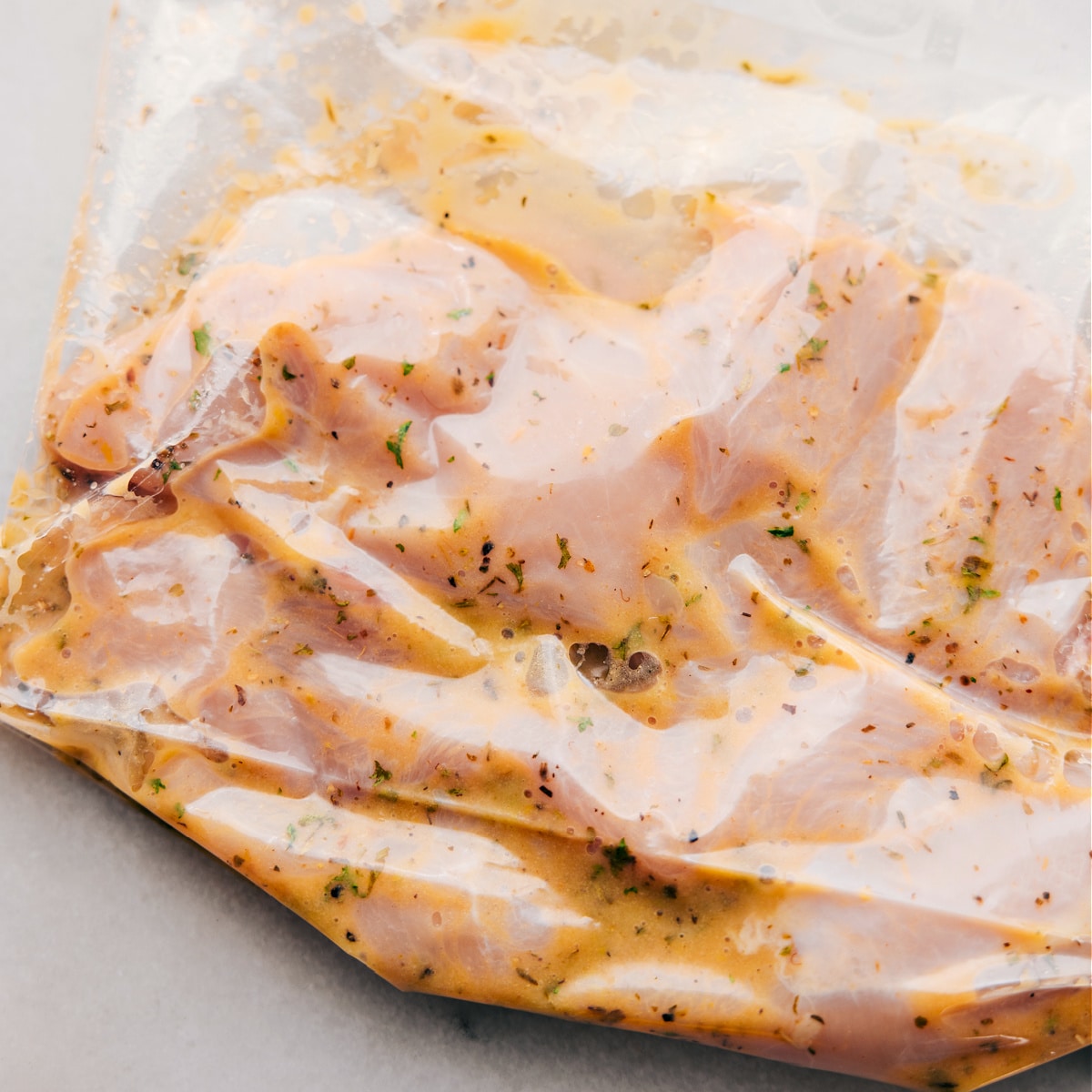 Marinating Italian Chicken The meat marinating in the dressing in a freezer size bag.