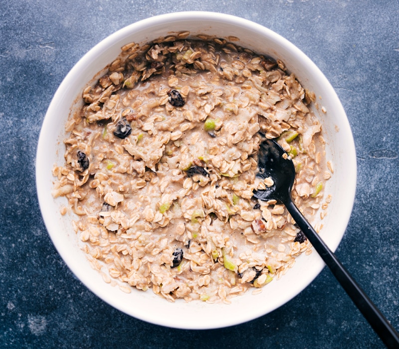 Loaded with oats, nuts, dried fruit, and plenty of apples -- it's delicious! Recipe via chelseasmessyapron #breakfast #best #quick #easy #simple #healthy #cleaneating #oats #bircher #muesli Image of a bowl of Bircher Muesli all mixed together